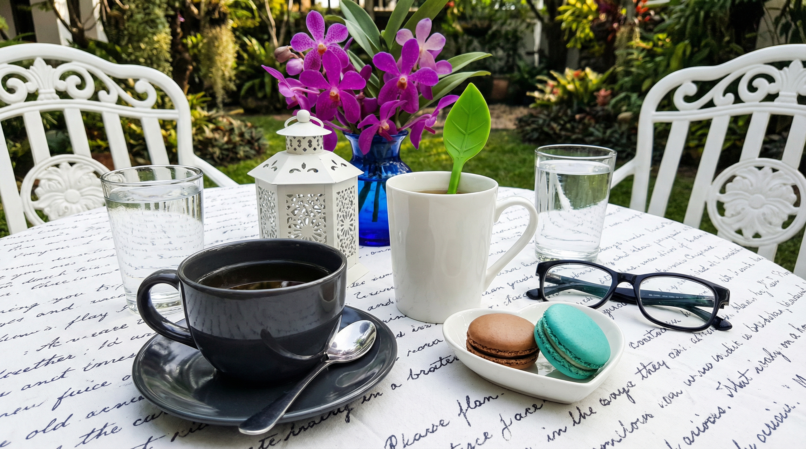 Ava Chocolate and Tea — a rich dark chocolate drink dusted with cocoa powder beside artisan chocolate pieces